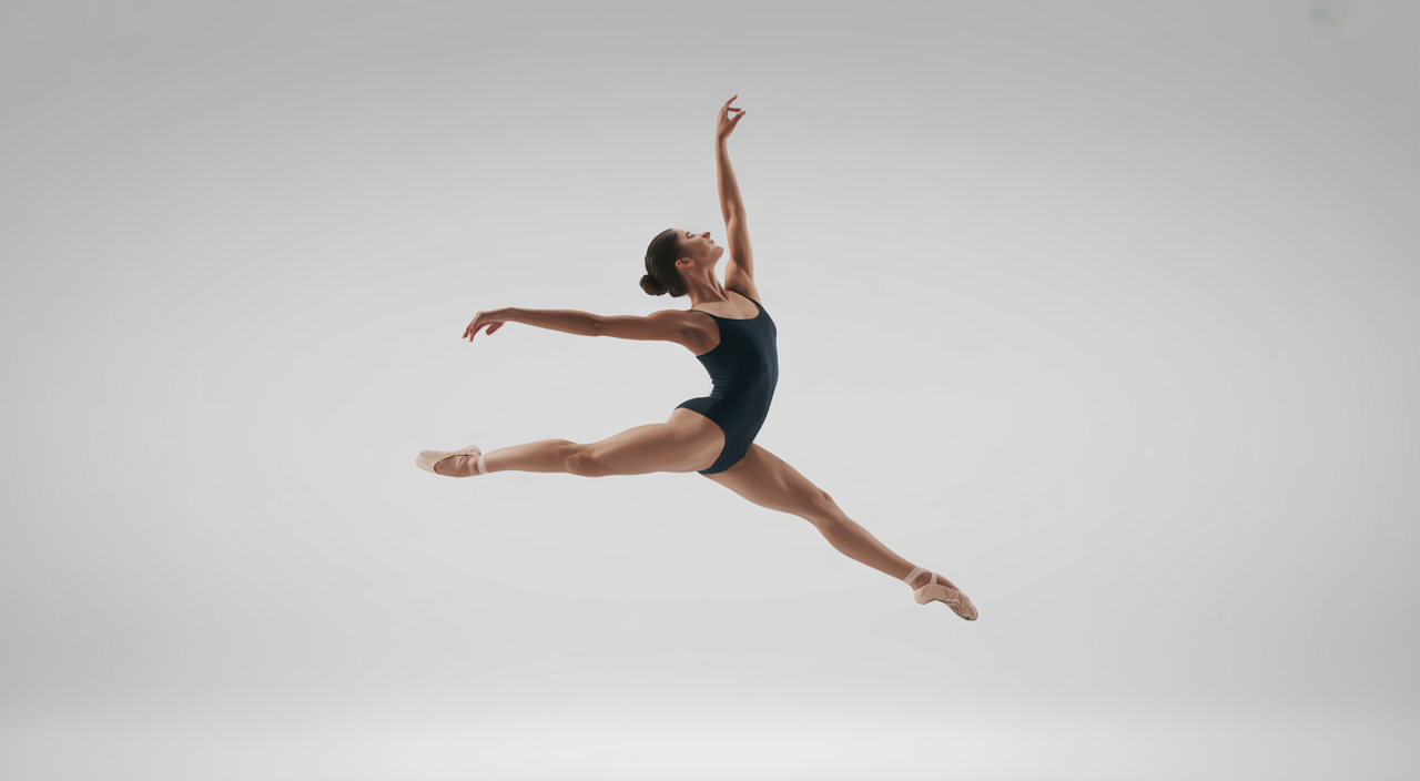 Female ballet dancer in a graceful leap in a modern studio, representing ballet studios in Toronto.